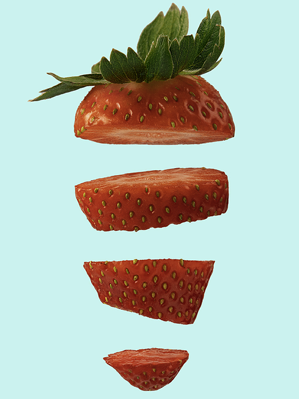 Red strawberry pieces on bright green background