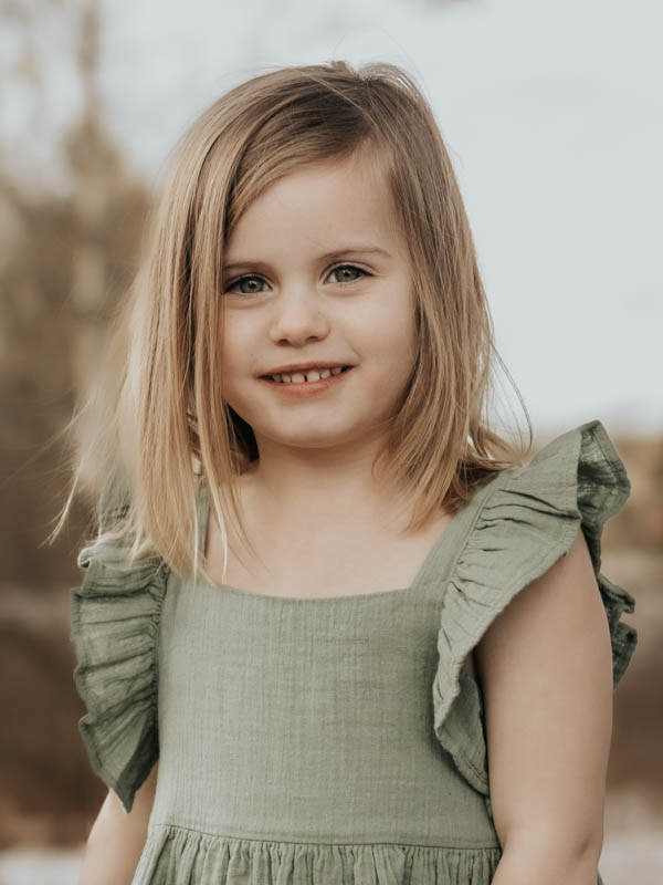 Portrait of little girl in green dress