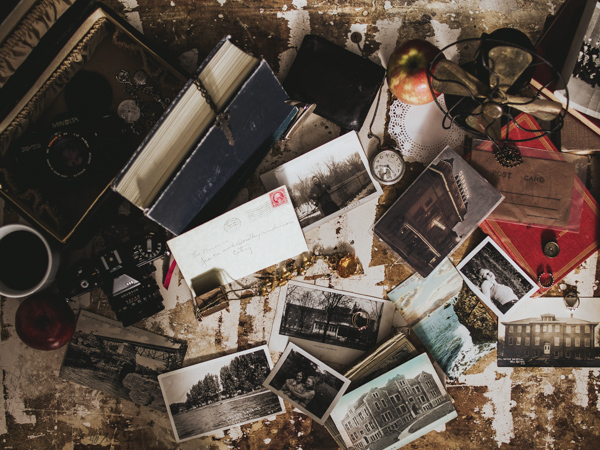 Overhead shot of vintage items scattered around including photos and books