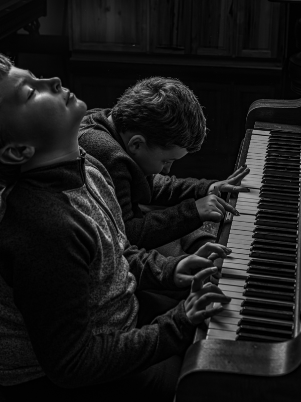 Two boys playing the piano, Black and white photo